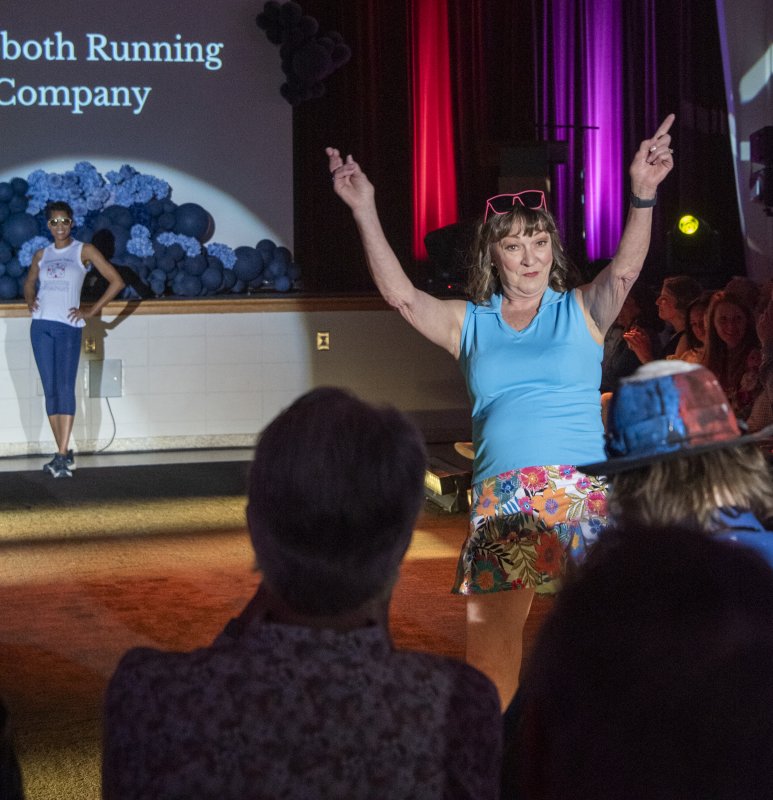 Maribeth Dockety engages the spectators while sporting Rehoboth Running Company fashion.